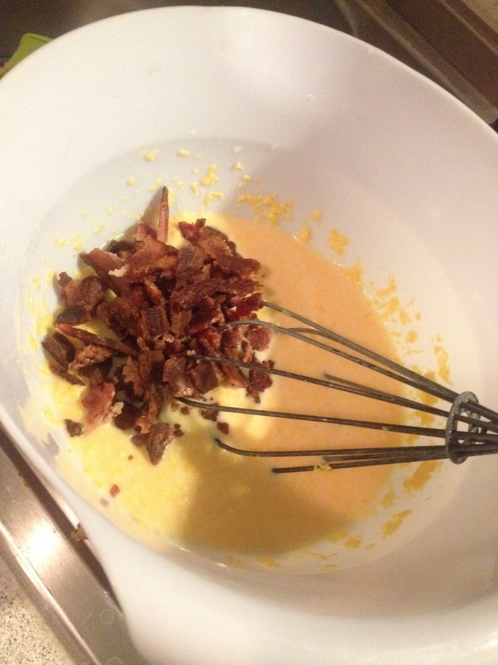 Add the BUTTER, CHEESE and BACON to the milk-egg mix.