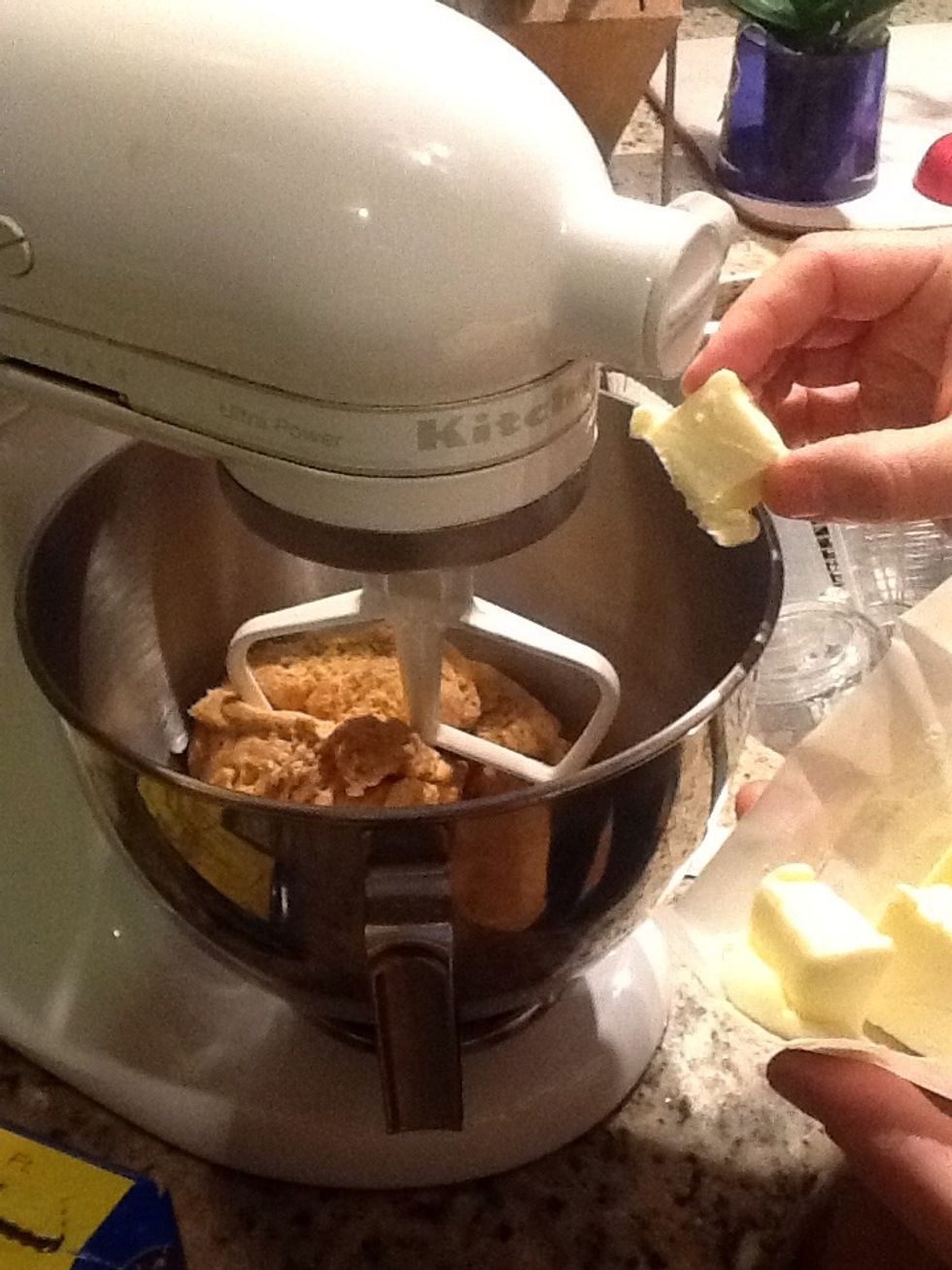 Add the butter in pieces while mixing