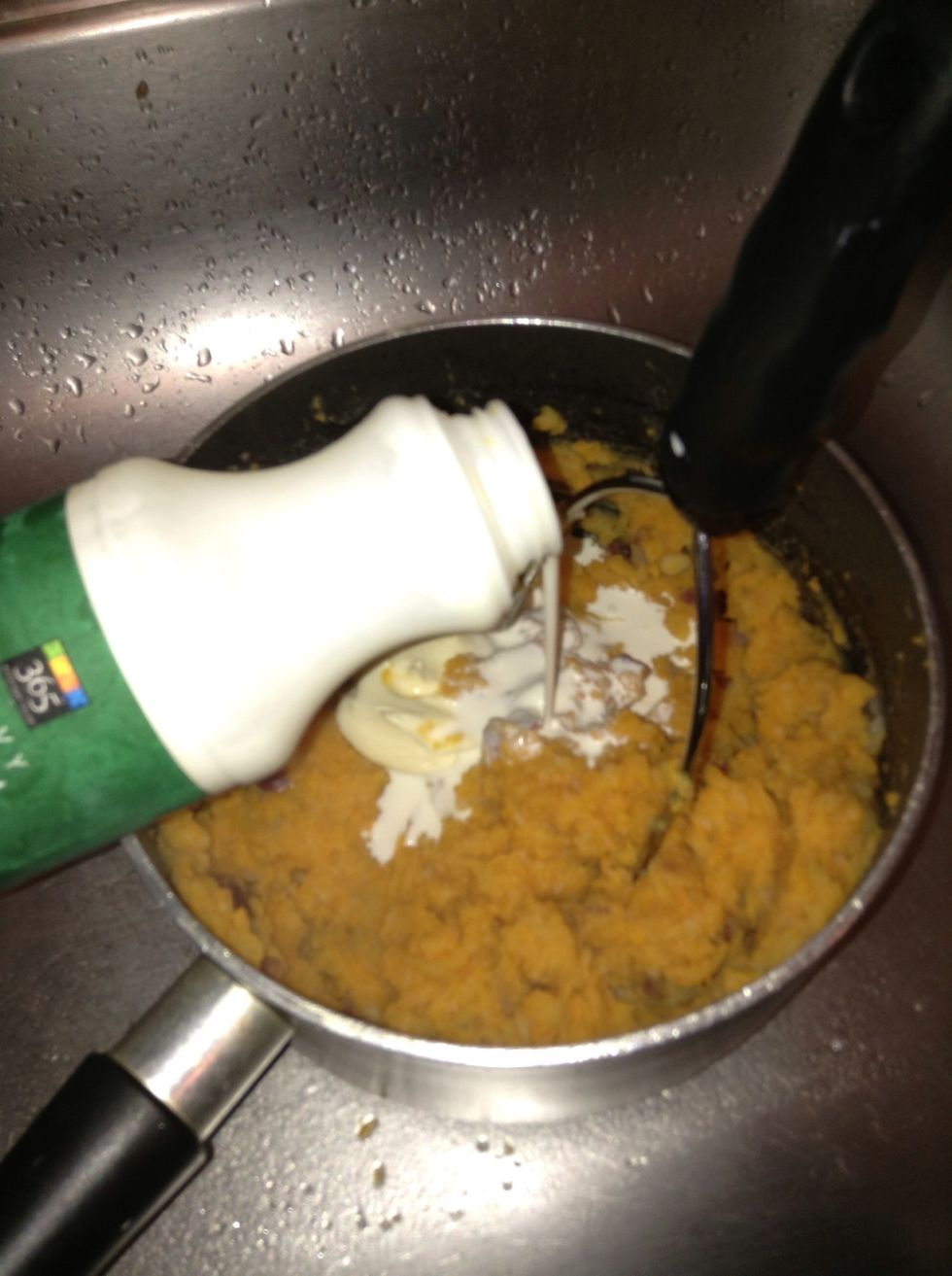 Add the butter/ margarine and heavy cream/ milk to the potatoes . Mix well
