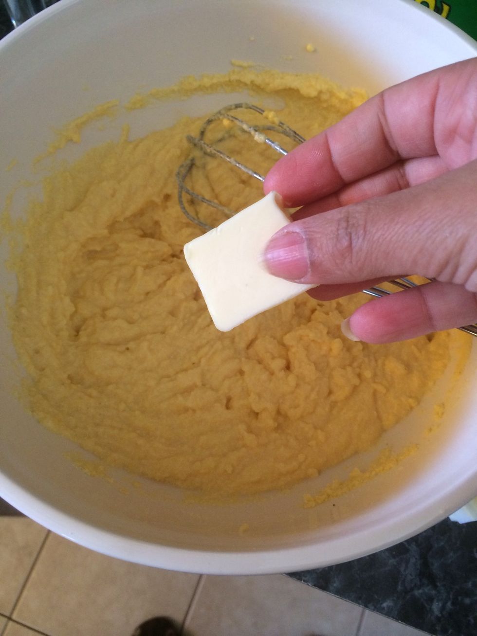 Add the butter to the cornmeal buttermilk mixture.