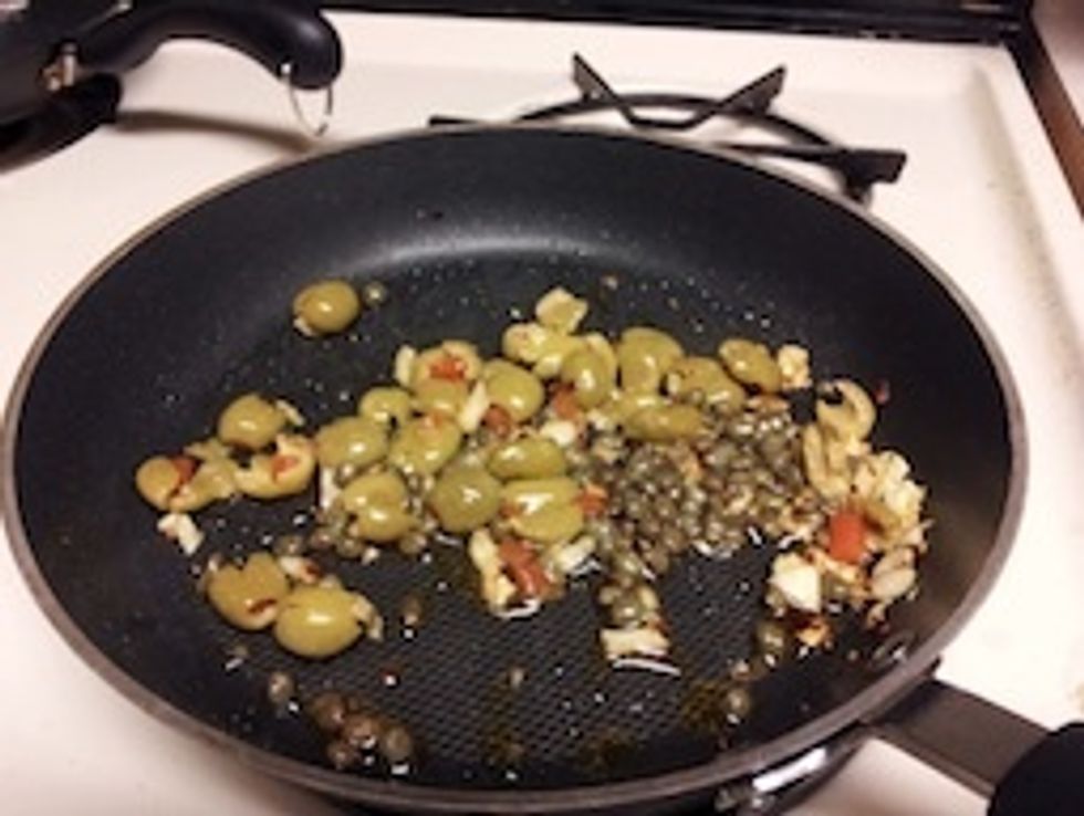 Add the capers and olives and fry 2 more minutes.