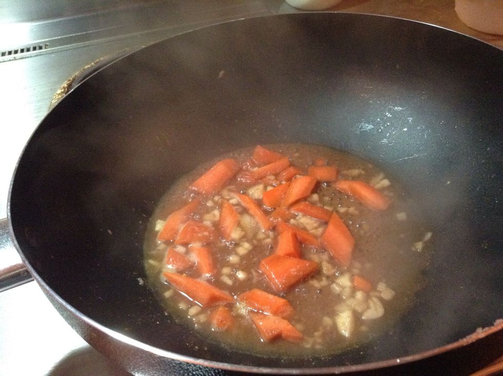 Add the carrots and water. When the water boiled add the seafood