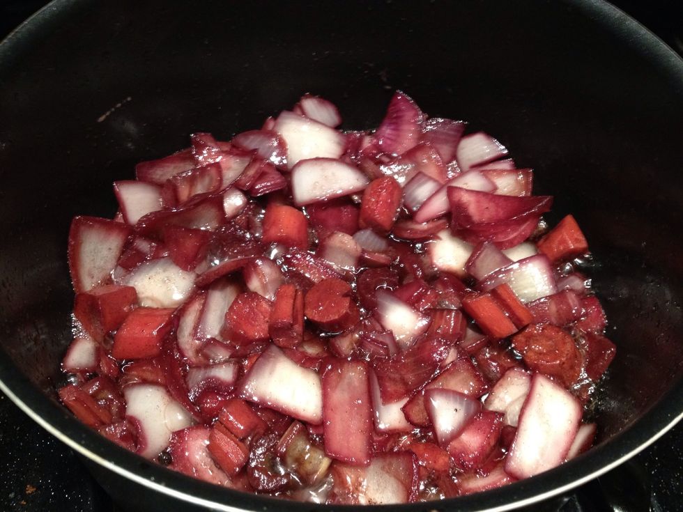 Add the carrots, onions and celery solids from the marinade into the pot.