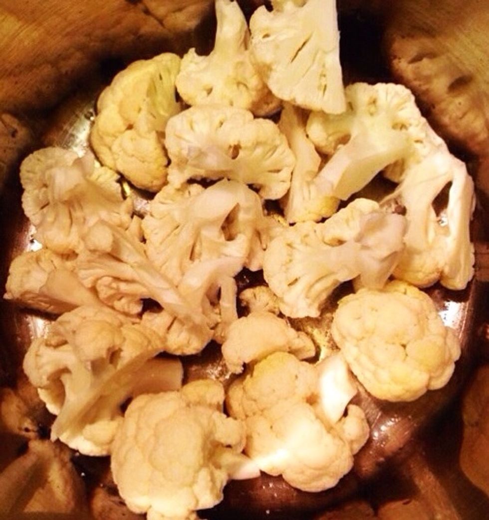 Add the cauliflower. Put on the lid and let the cauliflower get soft. It takes about 10-15 minutes.