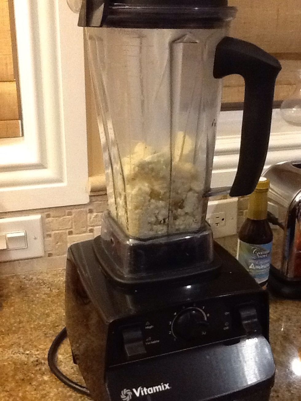 Add the cauliflower to a high speed blender. I'm using a vitamix which works well.