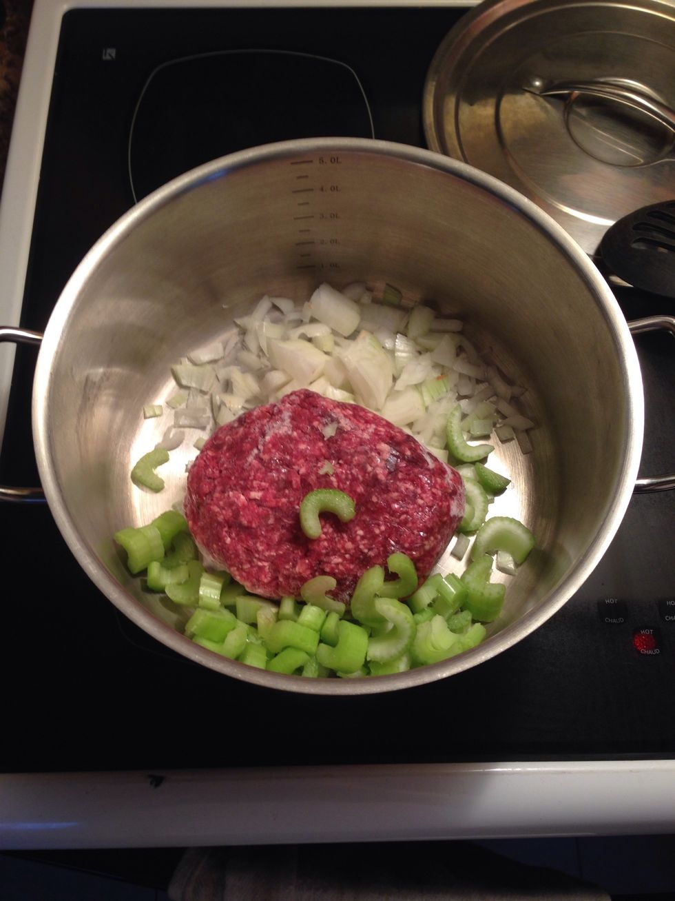 Add the celery to the pot and turn the burner up to five. (medium)