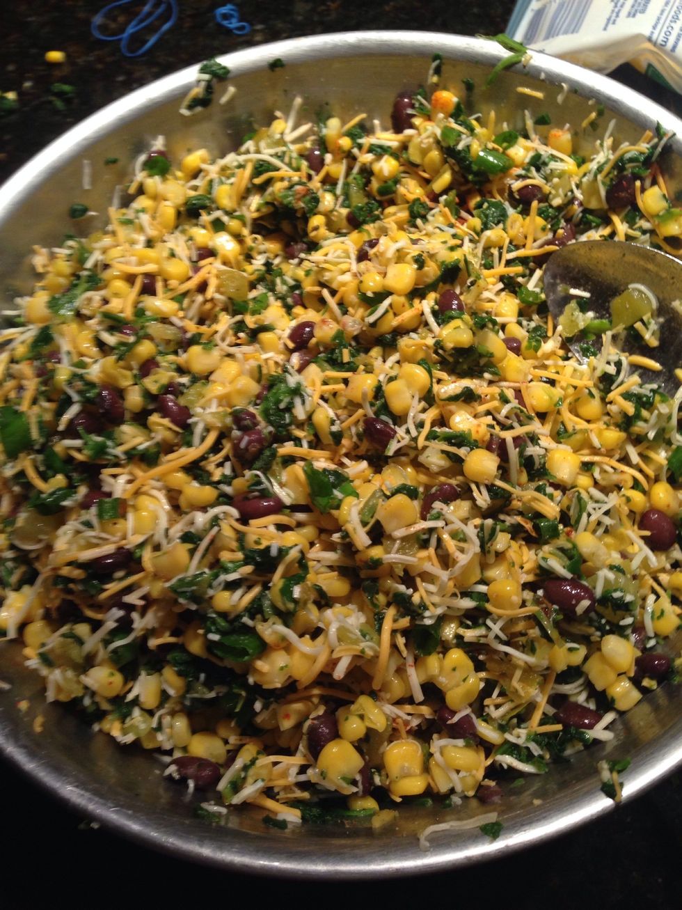 Add the cheese, corn, green chiles, chopped green onions, cumin, chili powder, salt, and cayenne pepper to the bowl and mix! (Mine is a bit heavy on the corn)