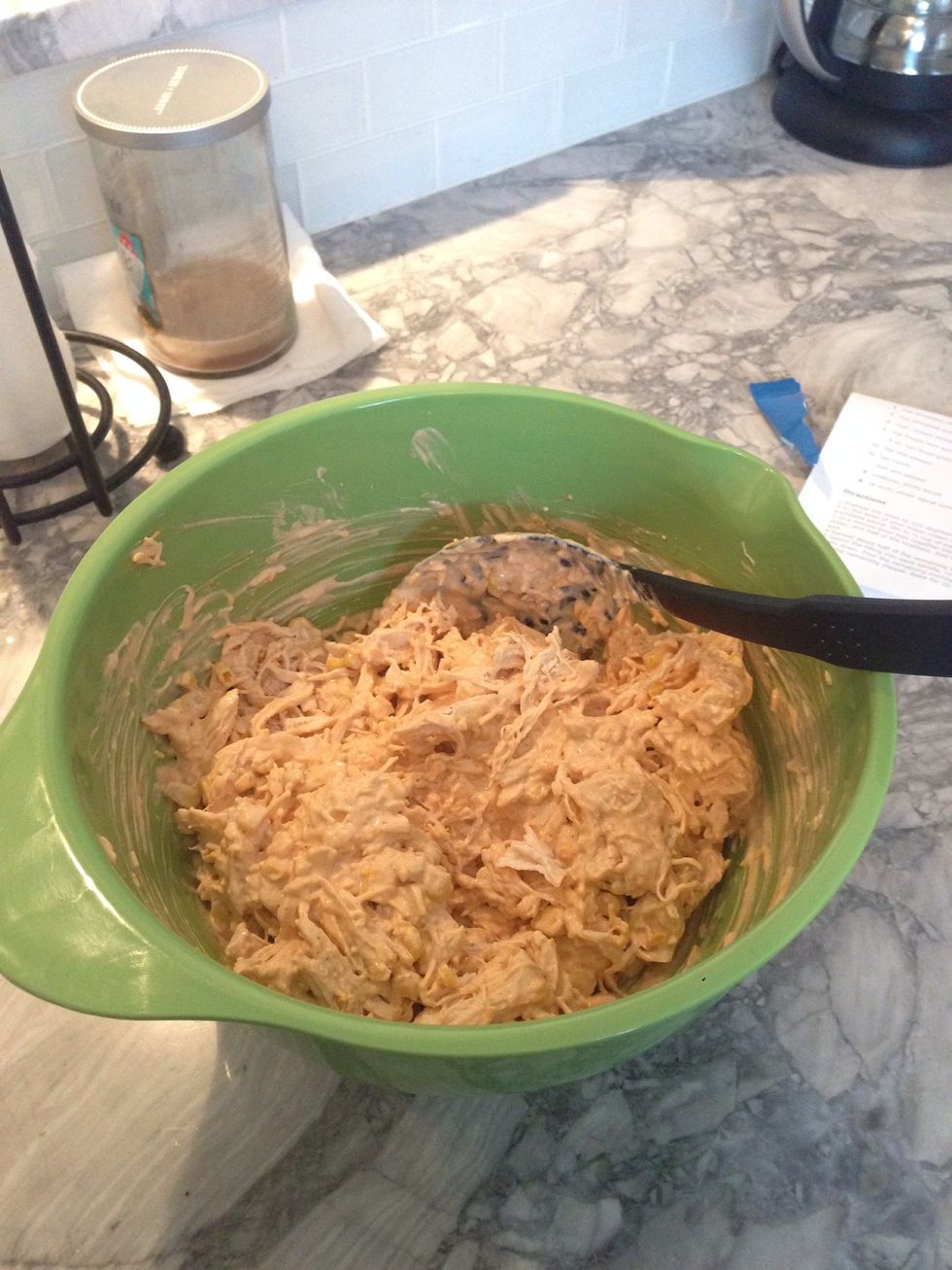 Add the chicken mixture to the original sour cream and cream cheese mixture.