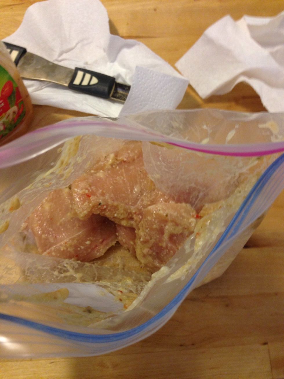 Add the chicken to a zip lock bag and pour the sauce over it. The chicken is filleted, but slices would work too. Marinade overnight for maximum tenderness.