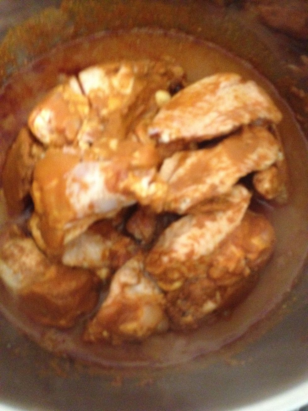 Add the chicken to the paste and stir to ensure they are well coated with the curry paste
