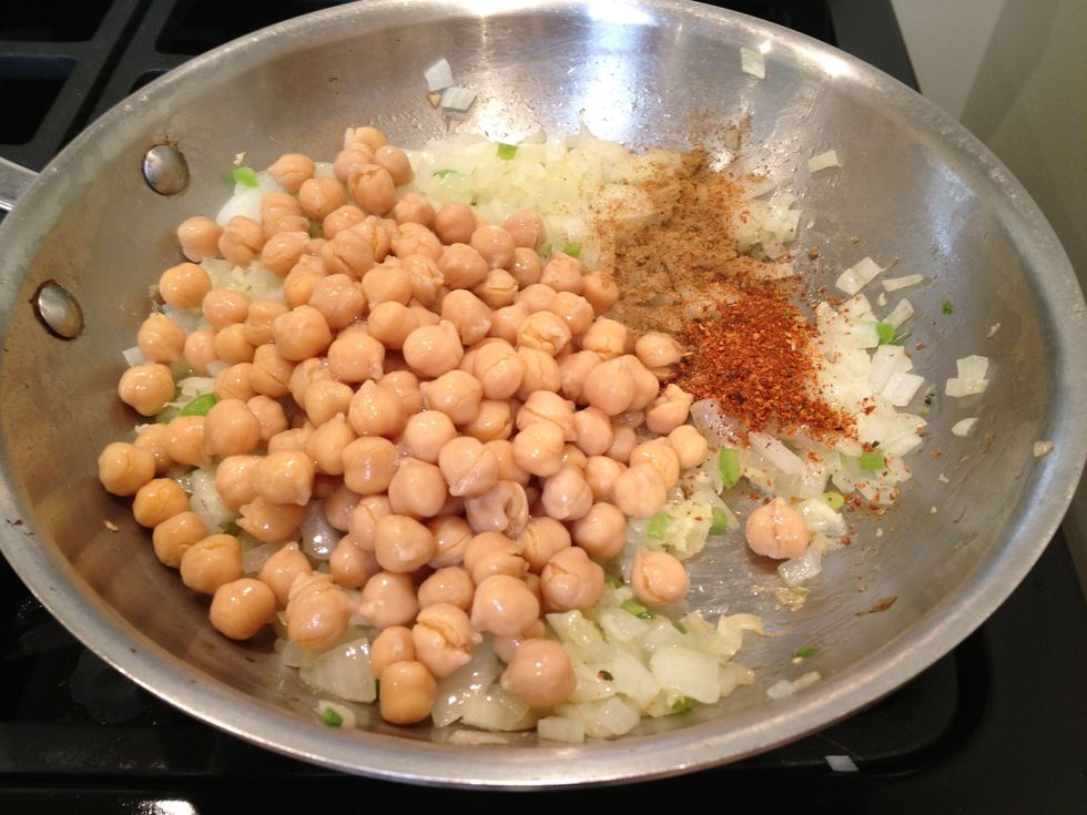 Add the chickpeas, the Harissa, and the Cumin.