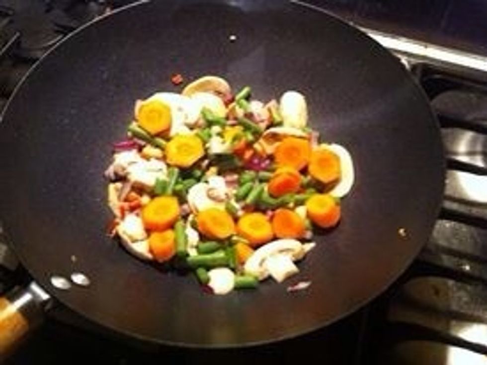 Add the chilli, beans, ginger, mushrooms, red onions and carrot constantly stir for about a minute or 2
