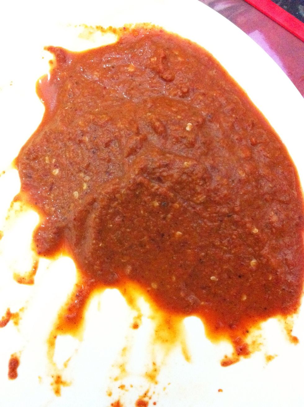 Add the chillies, ginger and garlic soaked in vinegar to the powdered spices. Add little water and grind all of it to a fine paste. Our wet paste is complete now. This is how it looks.