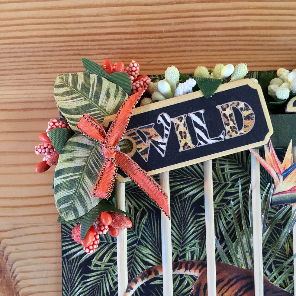 Add the chipboard and some paper flowers and a little bow.