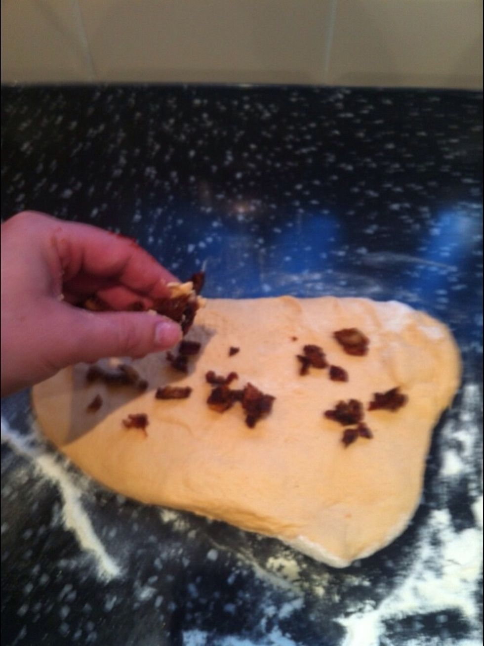 Add the chipped tomatoes to the dough