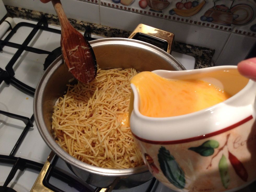 Add the chips to the codfish and then start pouring the egg mixture slowly while mixing everything