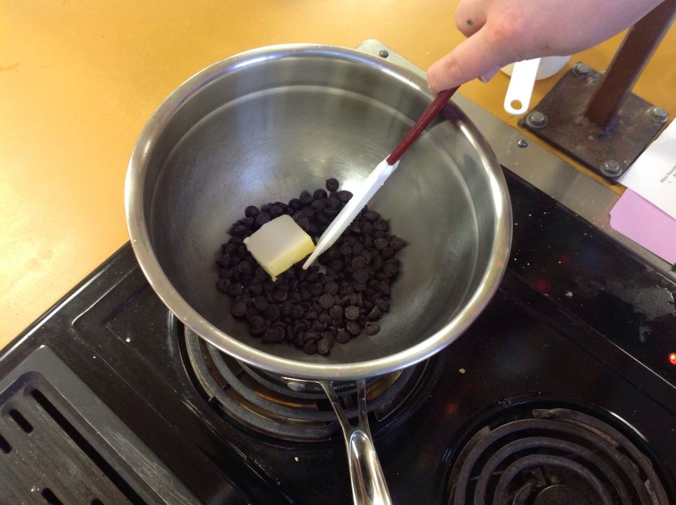 Add the chocolate and 2 TBS of butter into the bowl and begin melting it. You must stir constantly and scrape down the sides and the bottom of the bowl to make sure it does not burn.