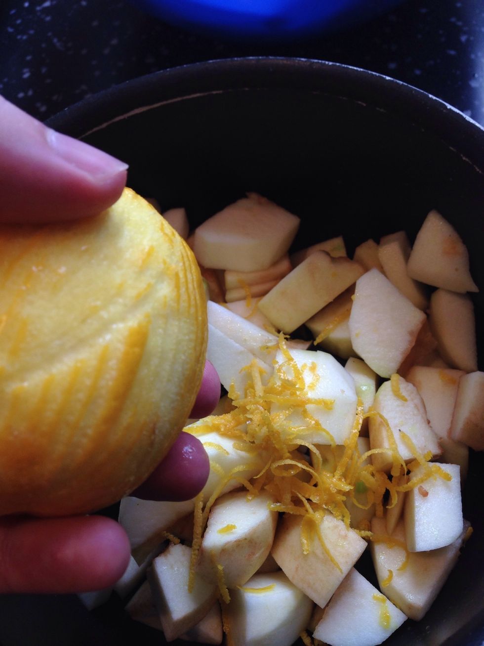 Add the chopped apples to the pan, and grate in the zest of half a lemon