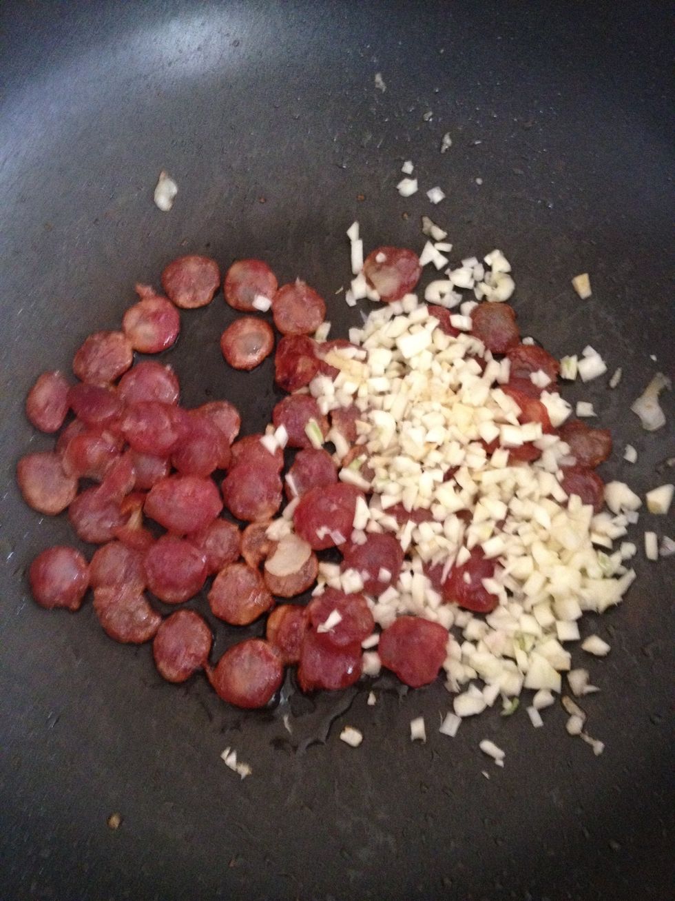 Add the chopped garlic to the chorizo and stir till the chorizo starts to shrink