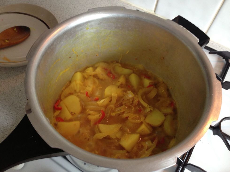 Add the chopped potato, and I add half a mug of water to keep the potatoes soft. Cook the water away on a high heat whilst stirring often. Then turn the heat back down to medium.