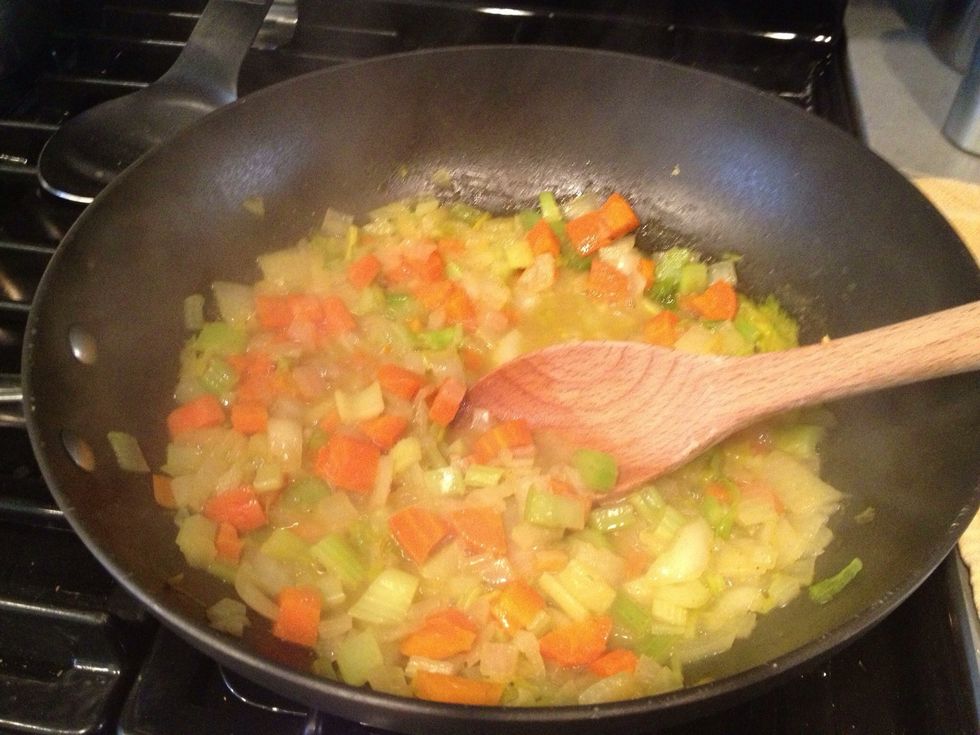 Add the chopped veggies to a deep pan or soup pot and soften over medium heat adding broth as needed to keep the mixture wet. About 8-10 minutes total. You can let it sit while the cauliflower roasts
