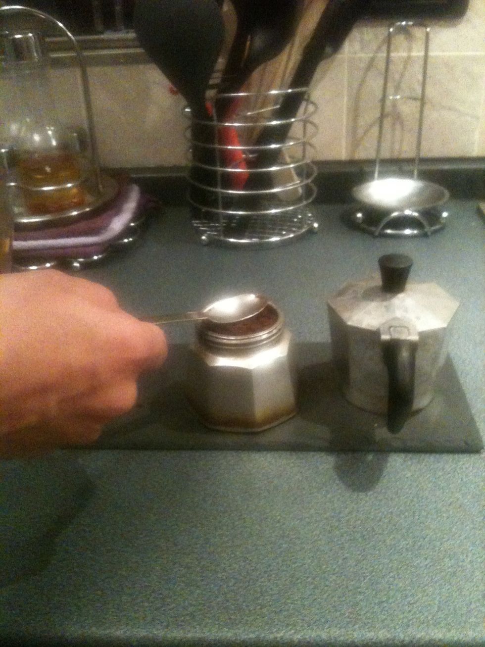 Add the coffee and level it with a spoon