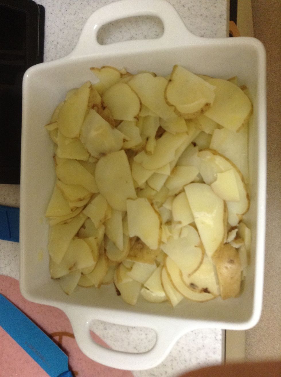Add the cool potatoes to a casserole dish