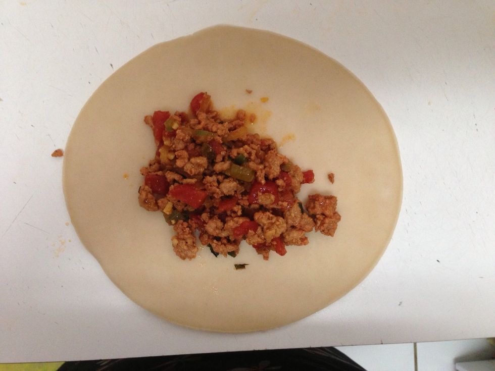 Add the cooled meat onto the dough. About 2 -3 tablespoons of meat per empanada.