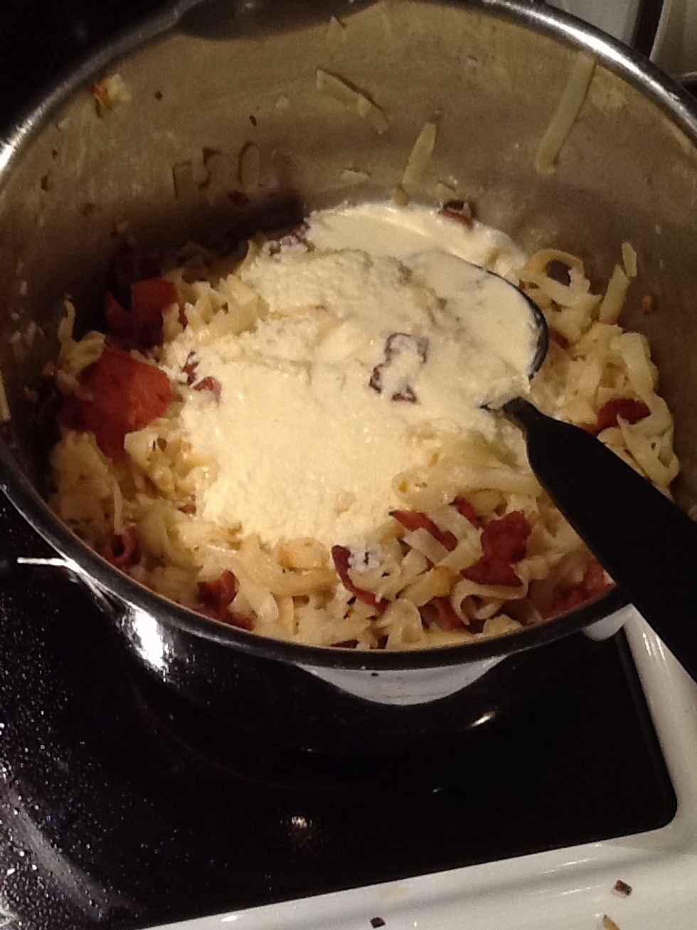 Add the cream and cheese to the pasta.