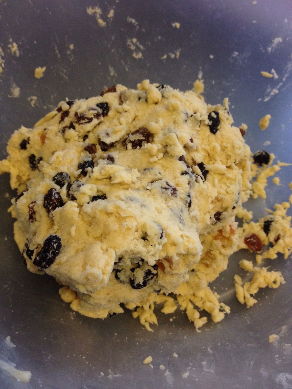 Add the currents, mixed fruit, egg and milk then kneed it together until sticky, if it's too dry add 2nd spoon of milk and kneed again, maximum of three - I only needed one :-)