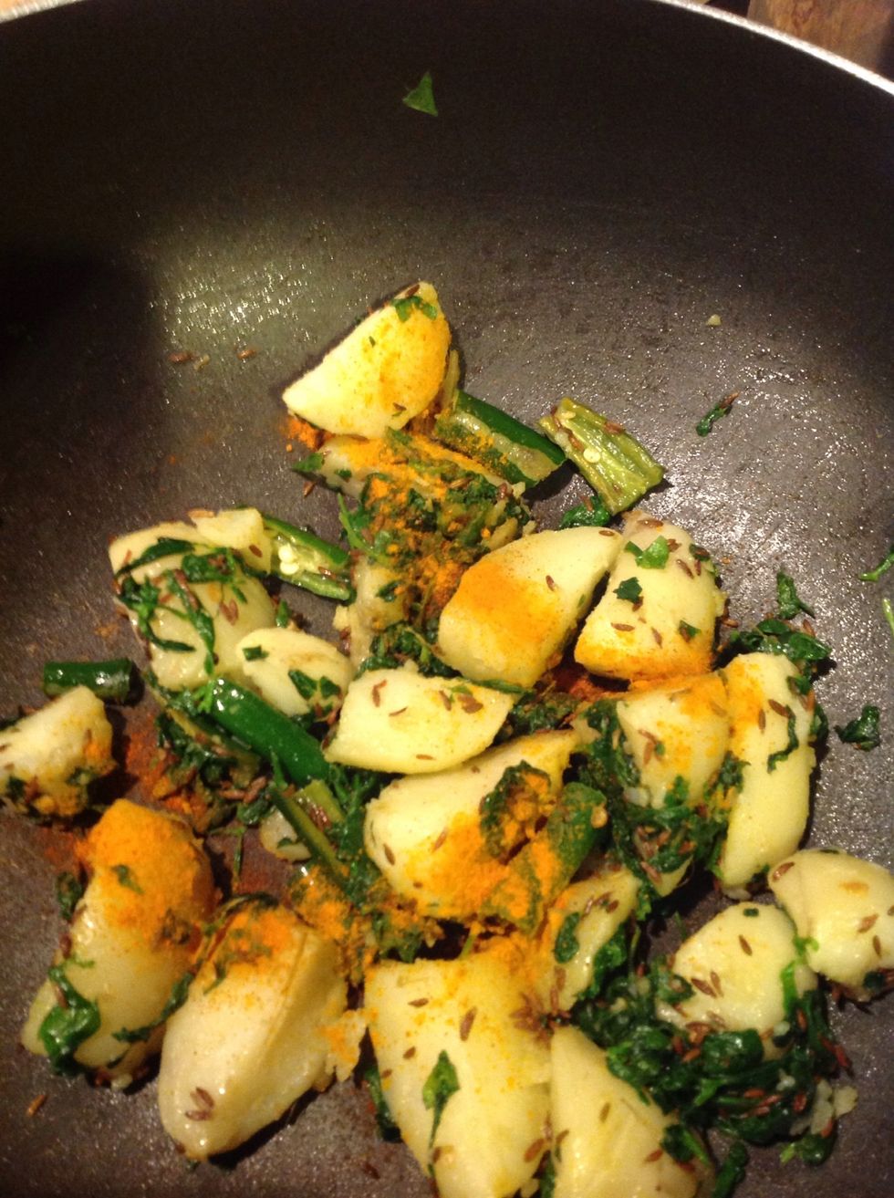 Add the diced potatoes. Sprinkle some turmeric and salt according to taste. Squeeze half a lemon juice to make it tangy.