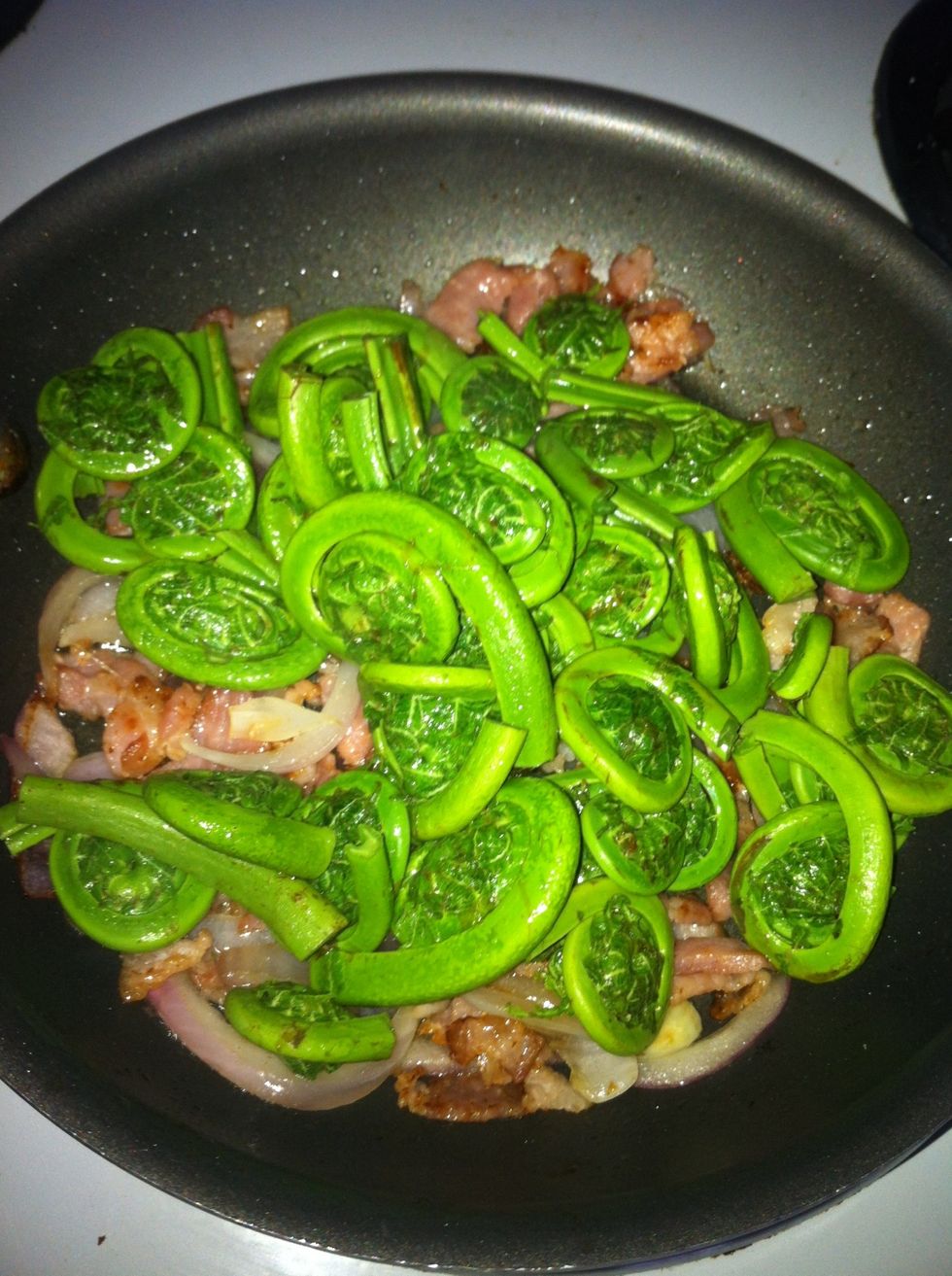 Add the drained fiddleheads into the pan and saut\u00e9ed for another 5-7 mins with the bacon and onion. I didn't add any salt because the bacon had enough salt already.