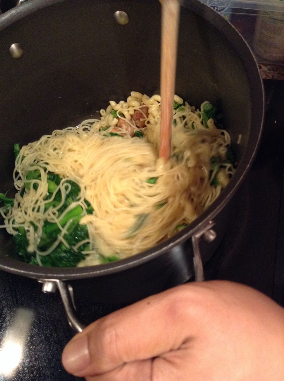 Add the drained pasta and rabe into pot.