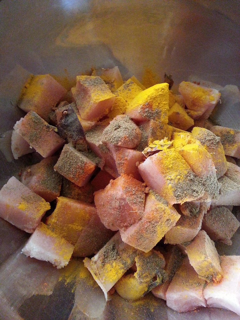Add the dried chilli powder, black pepper, turmeric, and garam masala to the chicken.