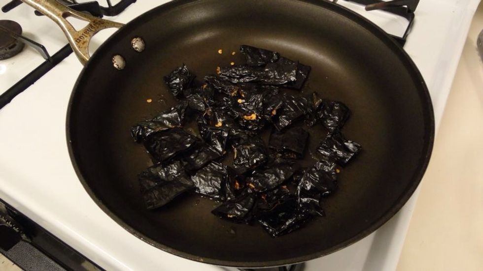 Add the dried pasilla peppers and fry for 3-5 minutes. Be careful! You don't want to burn these. The idea is to just sear the peppers a bit to enhance the flavor. This also flavor the oil.