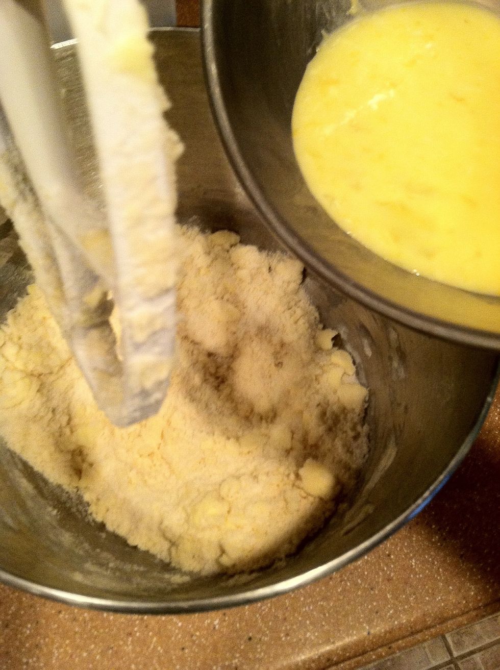 Add the egg and lemon mixture to the flour mixture. Beat on medium for 2 minutes until smooth and creamy.