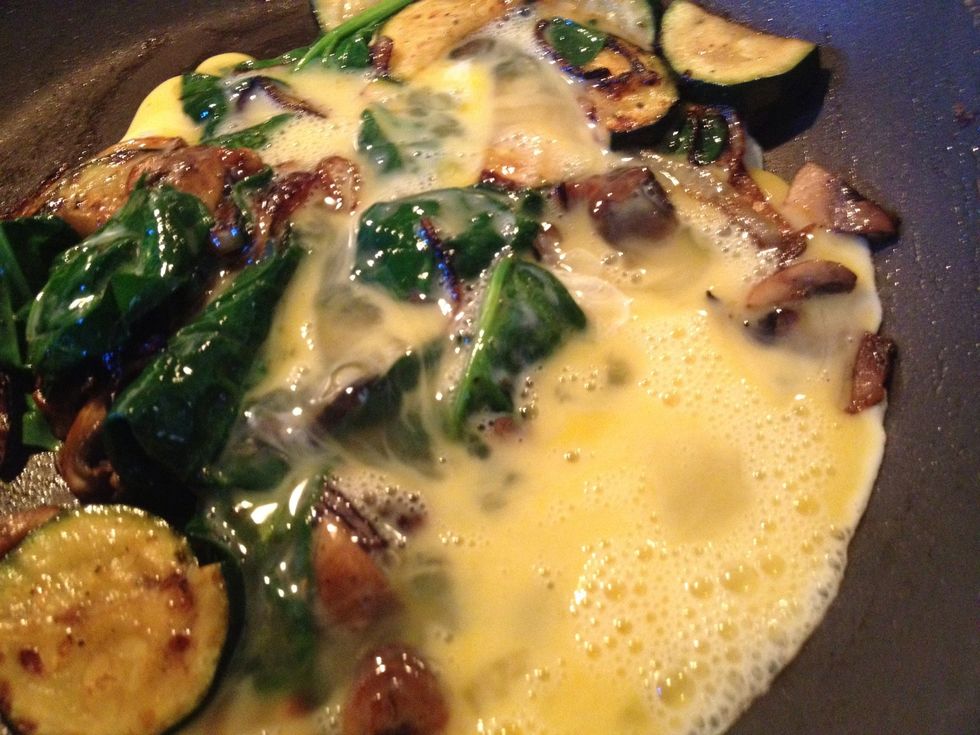 Add the egg mix to the mix. Sprinkle in a dash of salt & pepper. Stir it up!