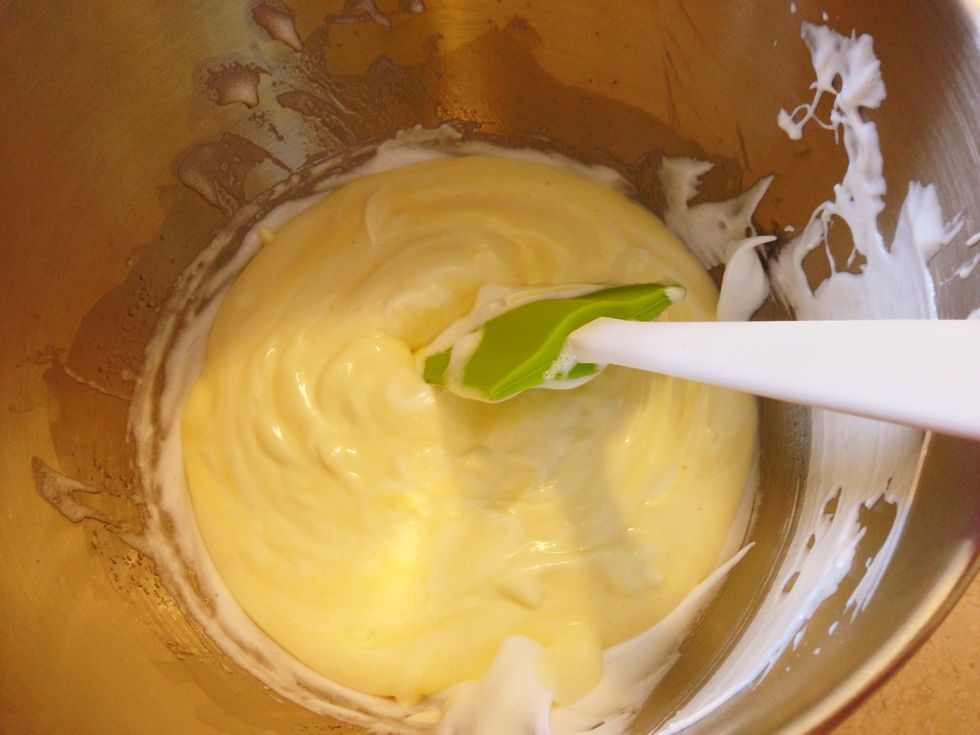 Add the egg yolk and egg meringue mixture to the rest of the meringue in your mixer bowl and fold till it's smooth and one colour.