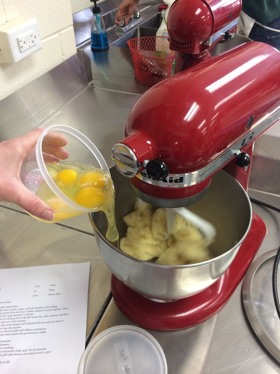 Add the eggs (200g) in stages,(they may not all be needed) add until the dough reaches ribbon consistency (it should fold over itself and start to fall of paddle when you stop the mixture)