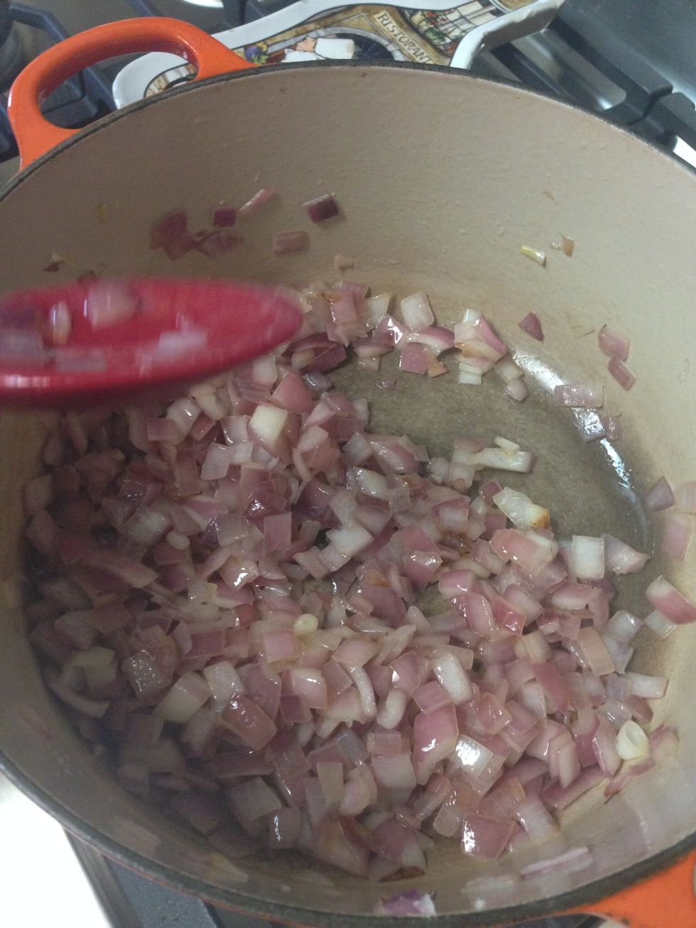 Add the extra virgin olive oil in a large cast iron Dutch oven and heat on medium high heat. Add onions and cook until translucent.