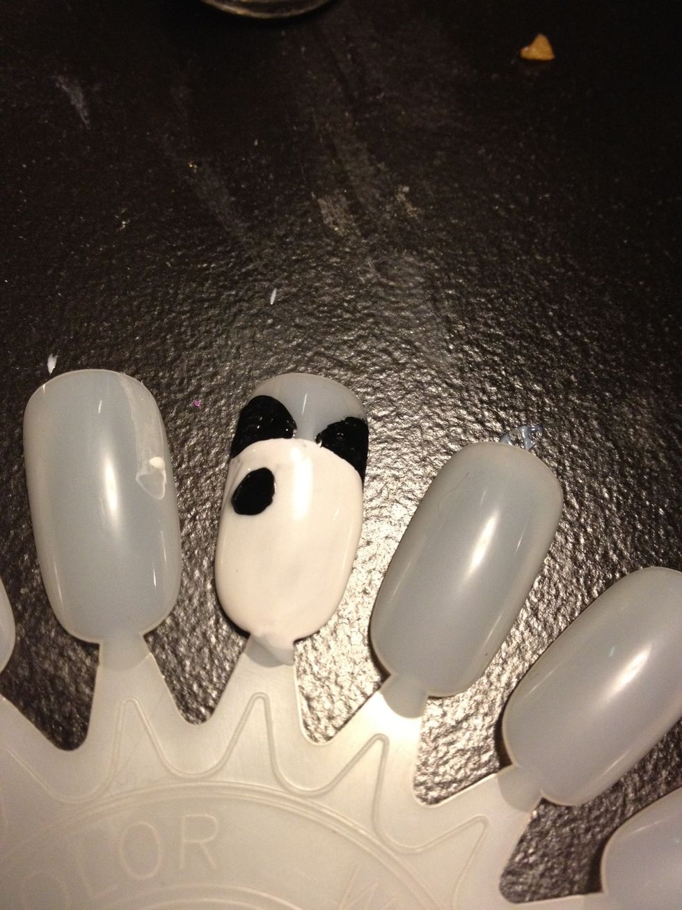 Add the eyes, they don't need to be perfectly round, because a pandas black circles around the eyes aren't perfectly round :)