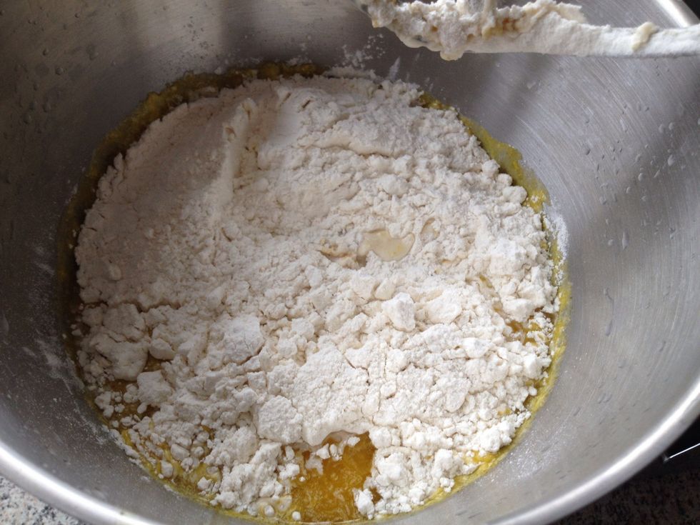 Add the first 300 grams of flour and mix it together