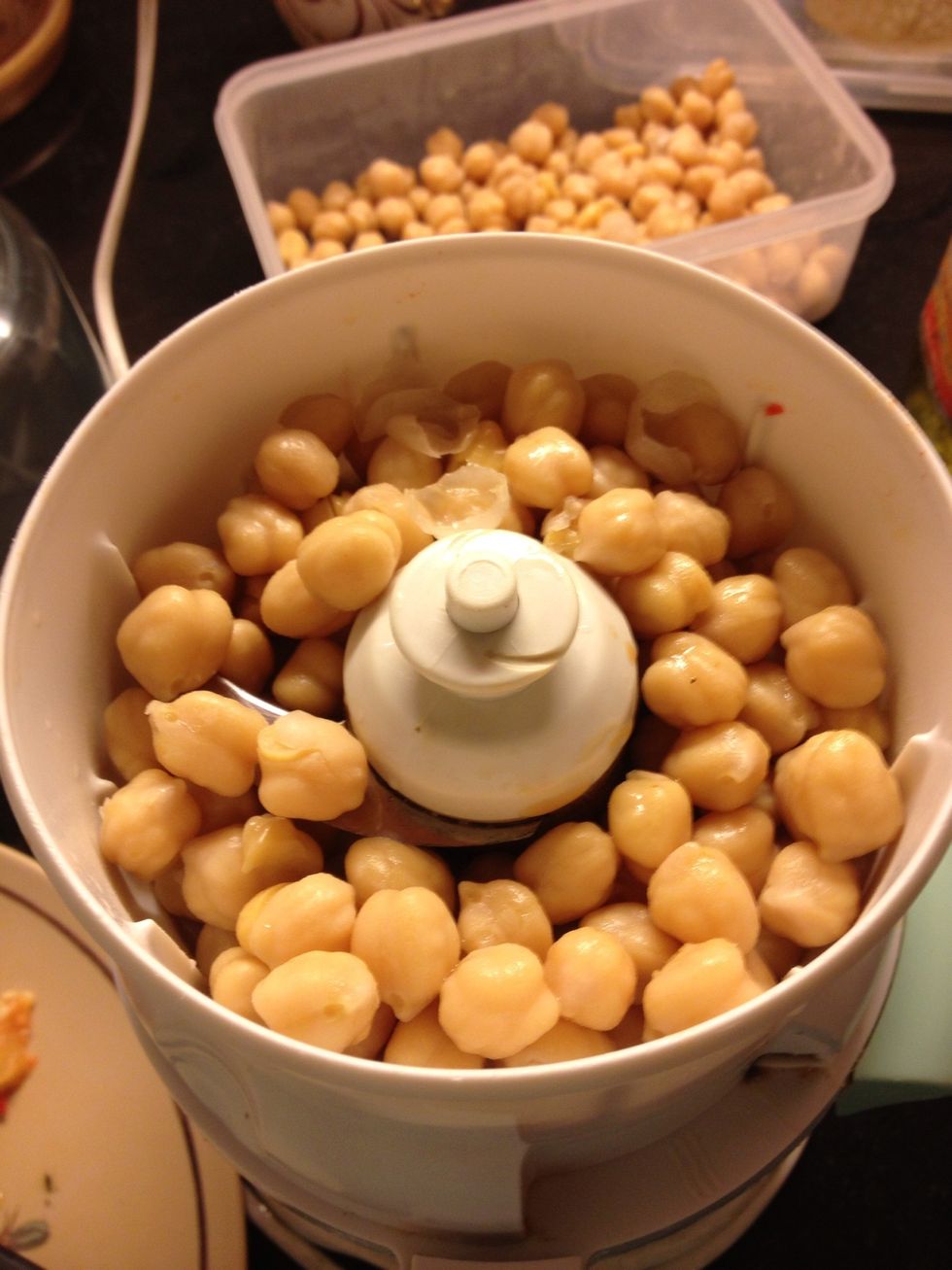 Add the first batch of the chickpeas in your grinder.