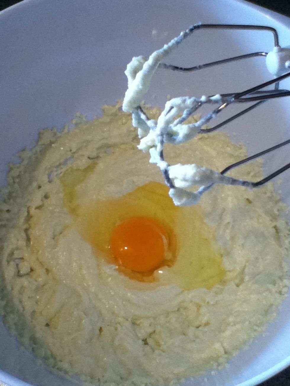 Add the first egg, mix, add the next egg and mix again :-)