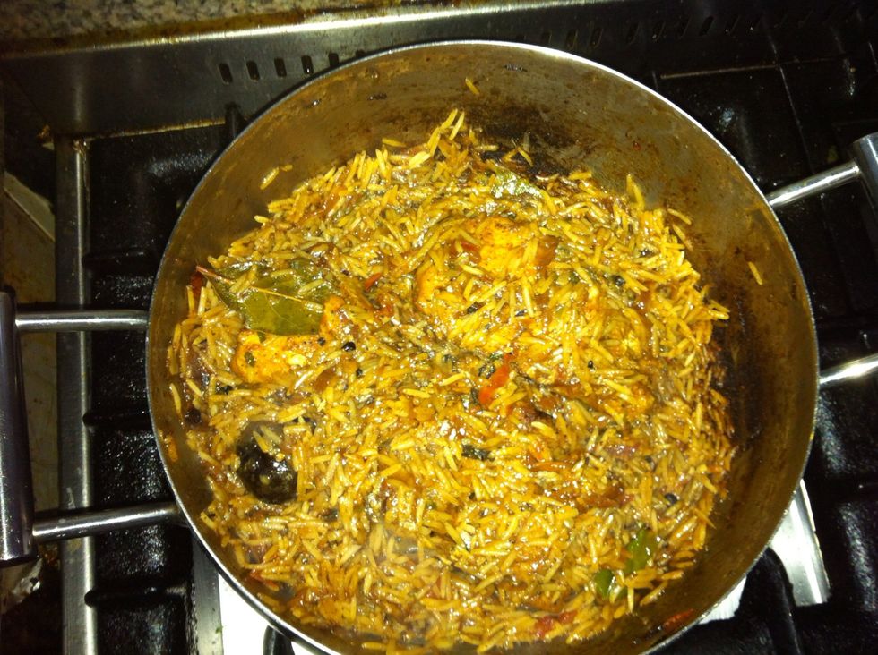 Add the fish back and bury it under the rice