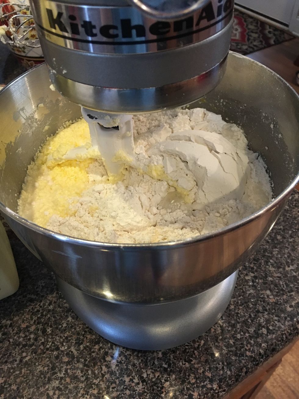 Add the flour and baking powder with one of the cups of milk