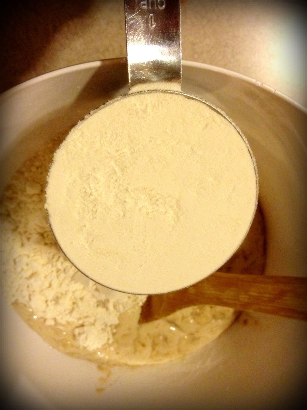 Add the flour but reserve about half a cup for kneading.