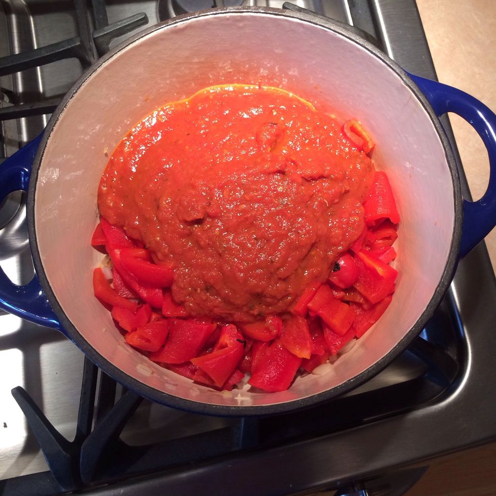Add the fresh oven roasted tomato sauce and half can of tomato paste to the stock pot.