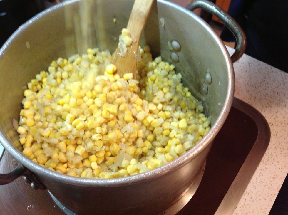 Add the frozen corn to the onions and melted butter.  When the icy cold corn hits the onions and butter the entire mixture will become solid.