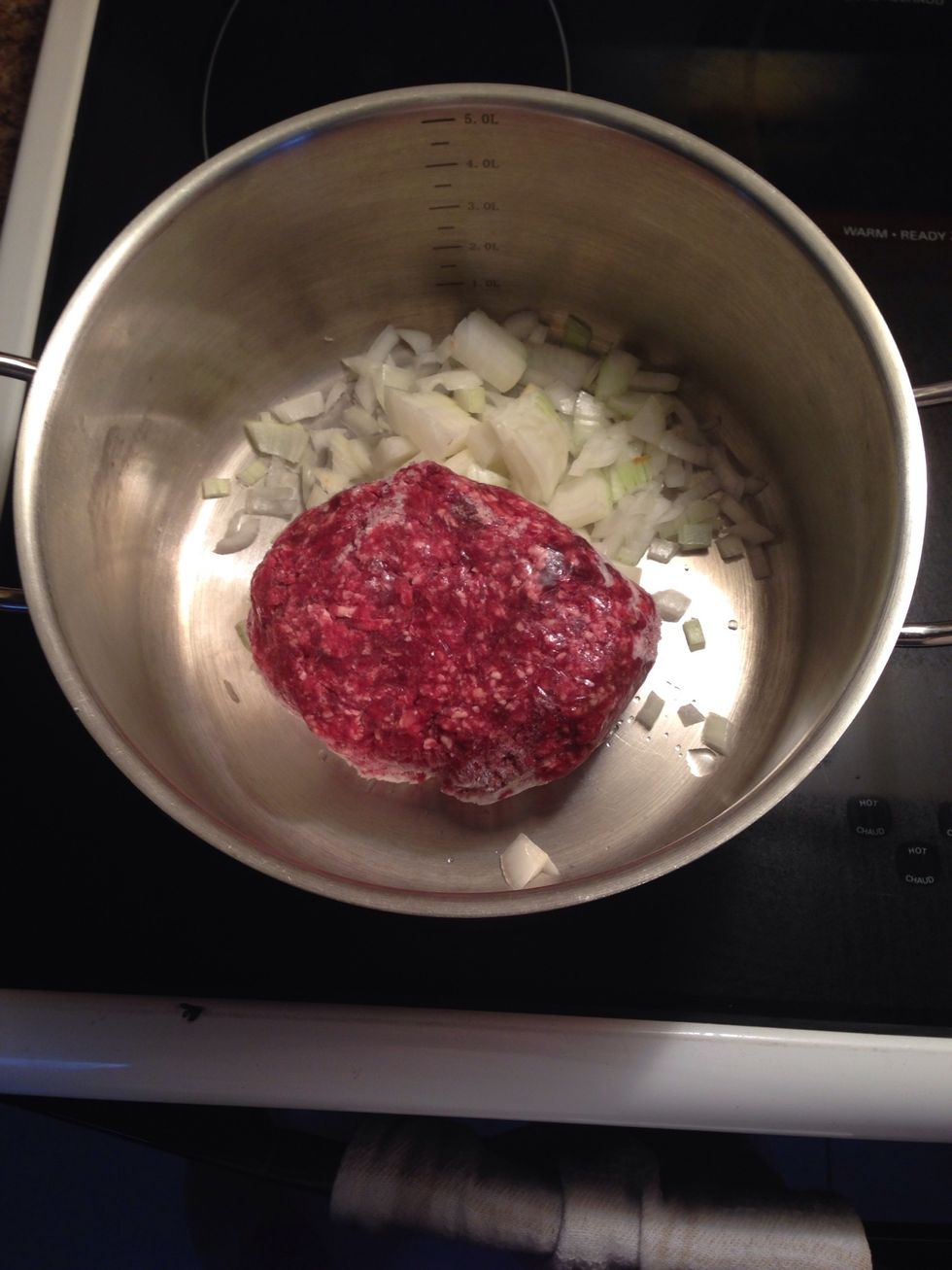 Add the frozen ground beef to the pot.